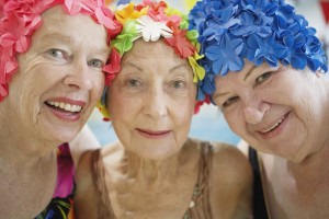 Three elderly women with swim caps